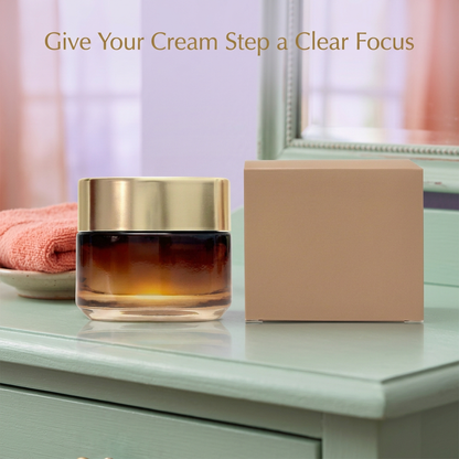 Face cream jar and carton beside a mirror and folded towel