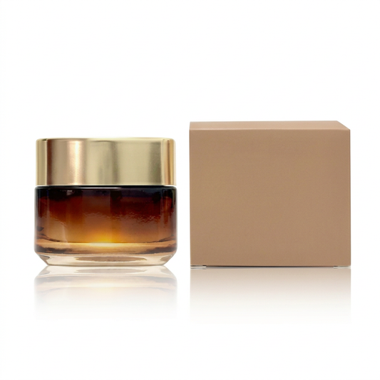 Unbranded amber-gradient face cream jar with gold lid and tan carton on a white background